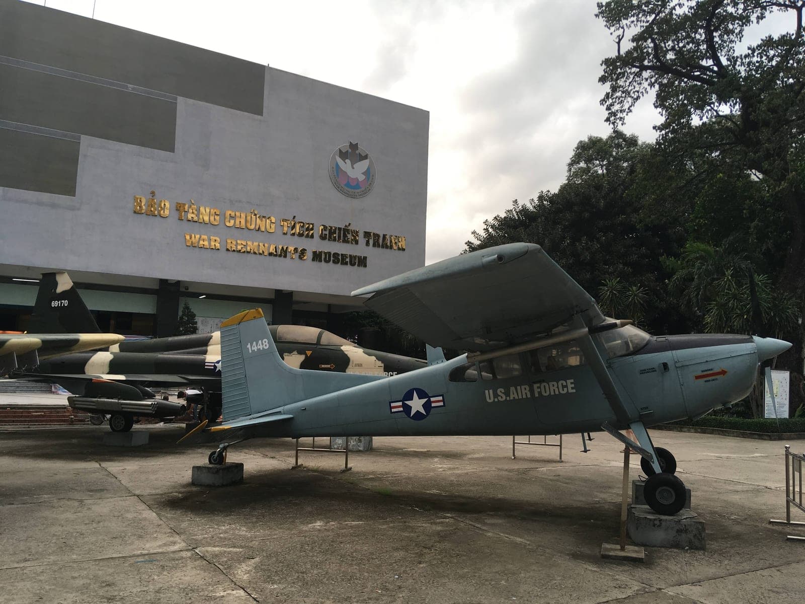 Exterior facade of the War Remnants Museum, a yellow colonial-era building in Ho Chi Minh City, Vietnam