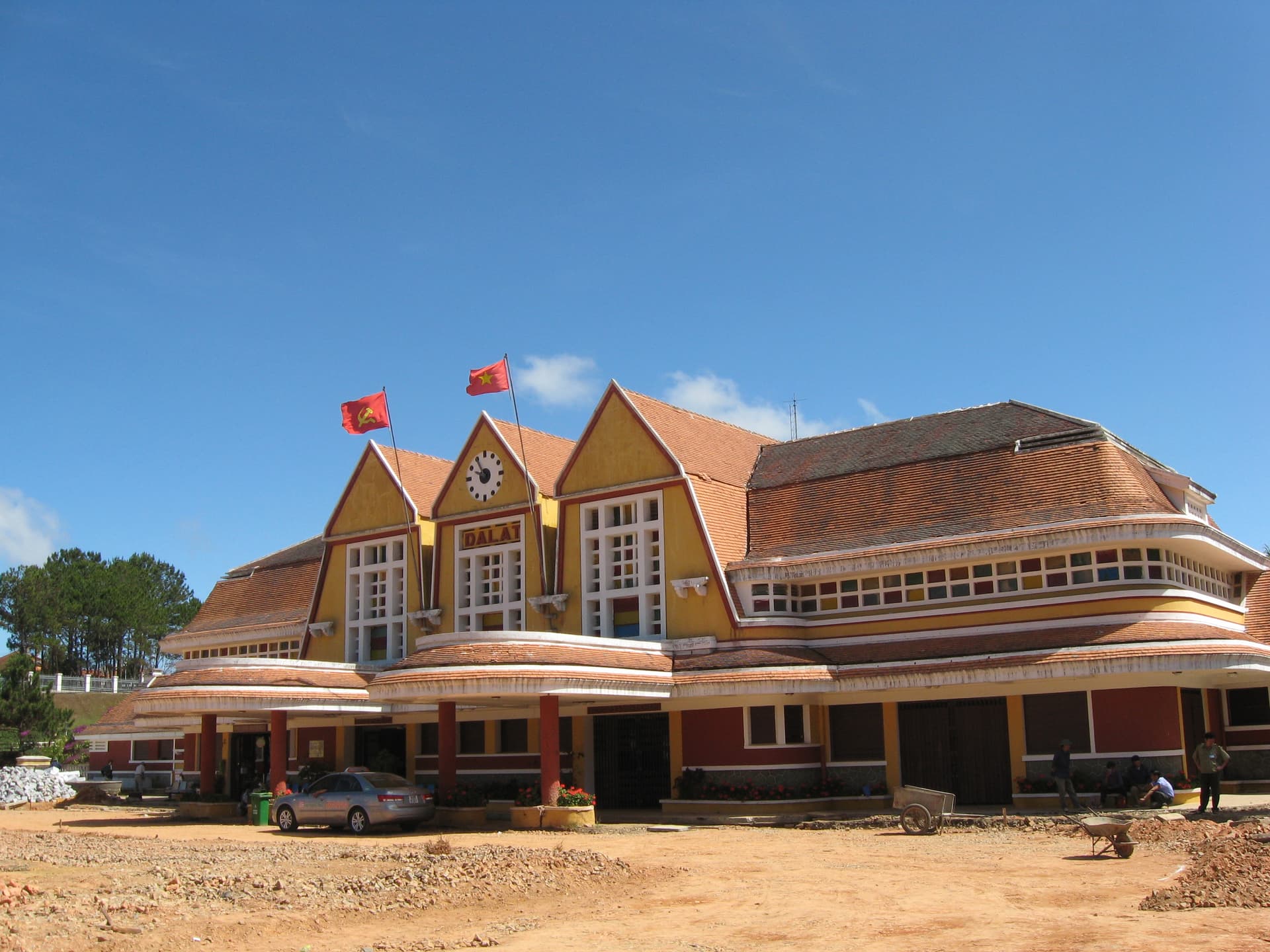 Exterior view of the historic Da Lat railway station with French colonial architecture and Art Deco design elements, a preserved structure in the cool mountain hill town.