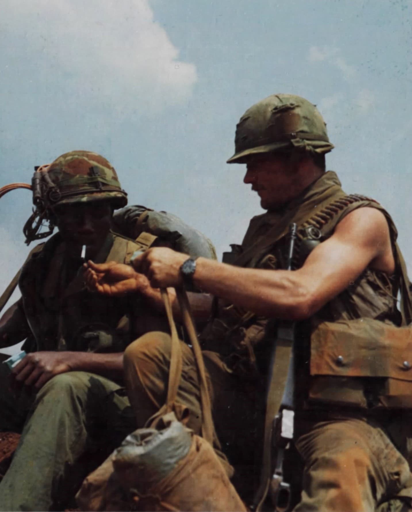 Two American soldiers, a Marine and a Cavalryman, smoking at Khe Sanh Combat Base during the 1968 Vietnam War siege.
