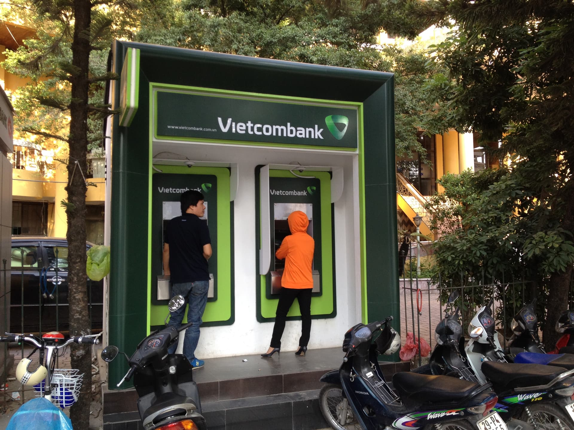 Vietcombank ATM kiosk mounted on a street corner in Hanoi's Văn Cao district