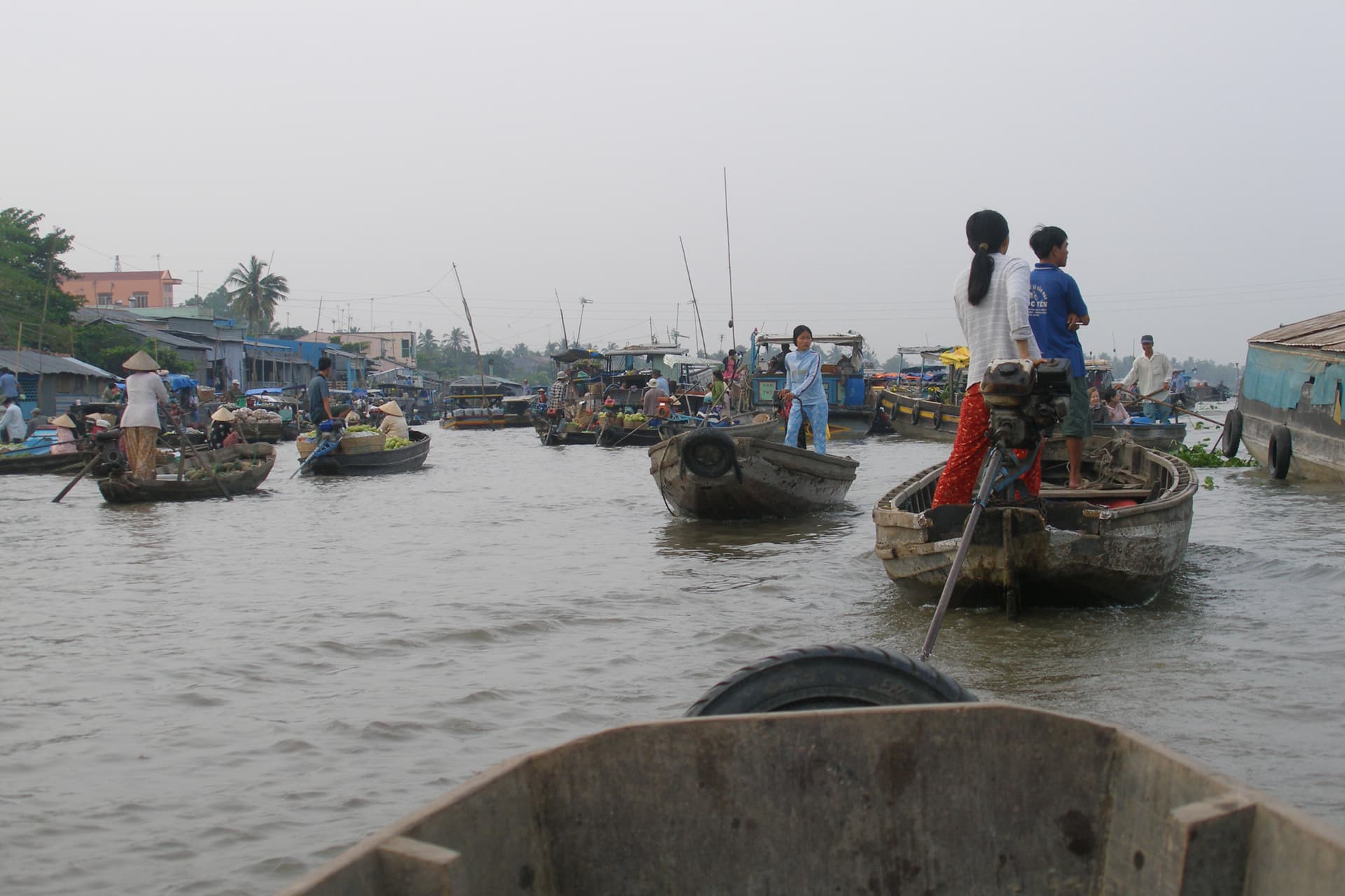 Colorful boats laden with produce gathered at Cai Rang floating market in Can Tho, Mekong Delta, Vietnam
