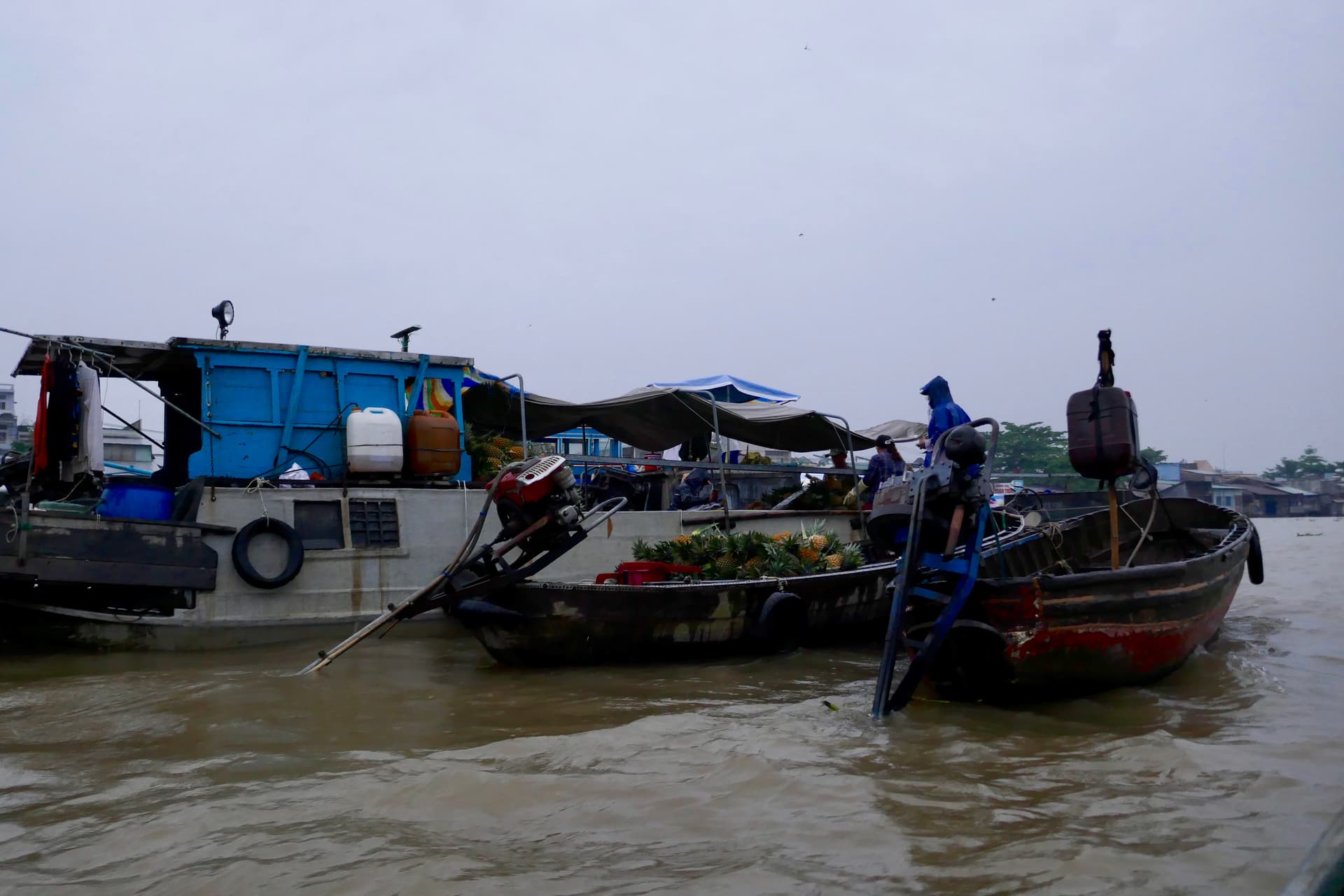 Colorful boats laden with fresh produce congregate at Cai Rang floating market before dawn