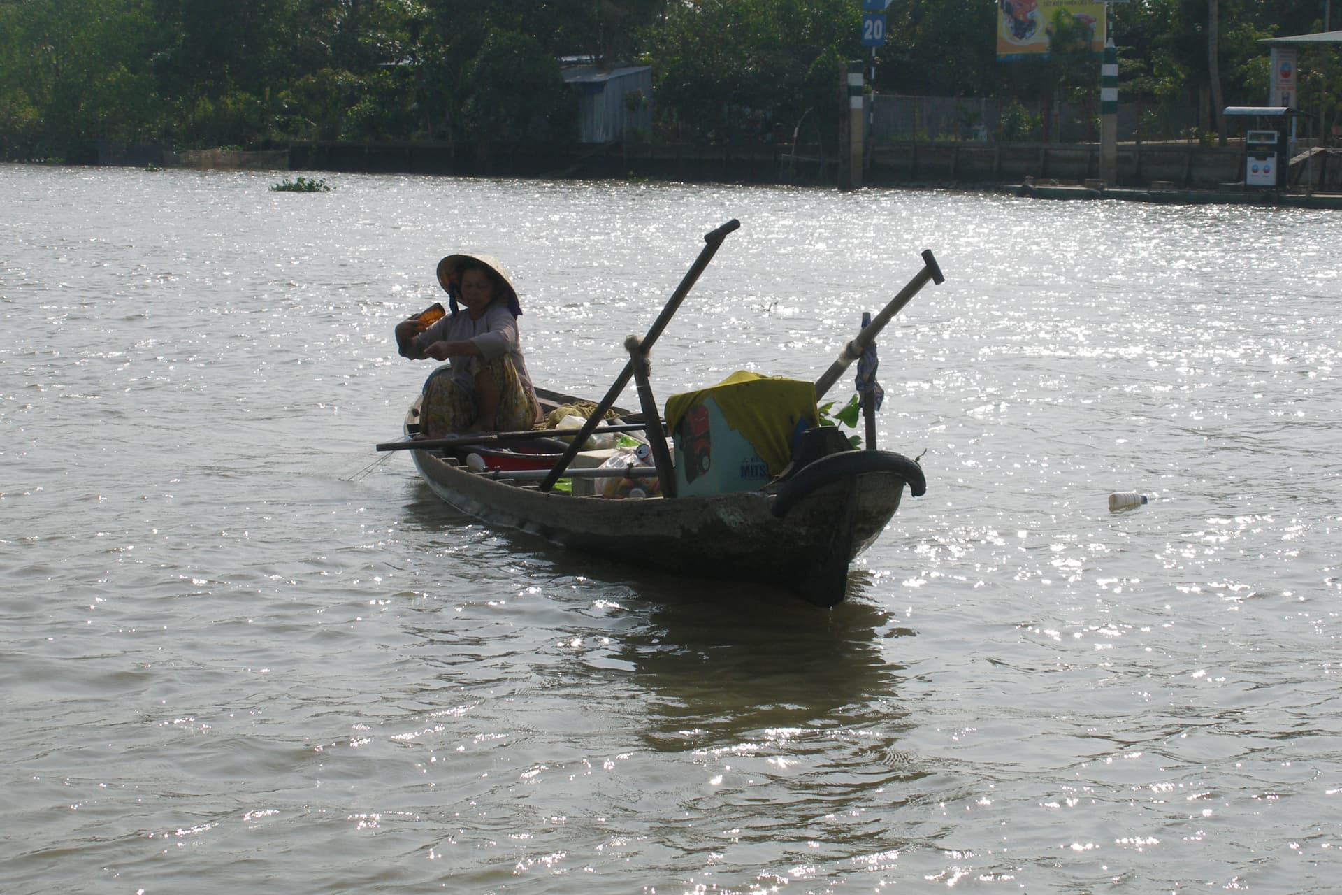 Waterway in Phong Dien with boats and mangrove vegetation along the Mekong Delta river landscape
