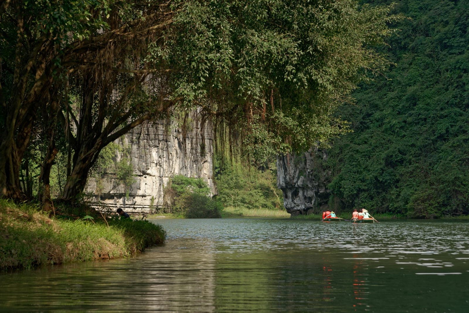 Dramatic karst limestone landscape with emerald waters at Trang An Complex in Ninh Binh Province, Vietnam.